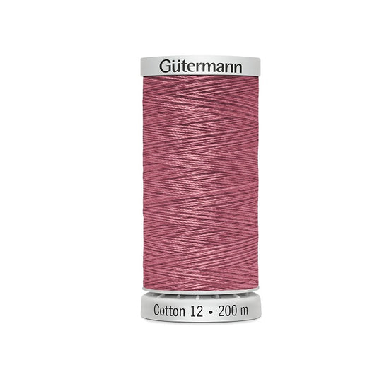 Spool of dark rose pink thread with Gutermann Cotton 12 branding.