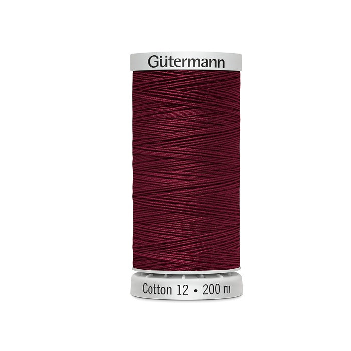 Spool of dark red thread with Gutermann Cotton 12 branding.