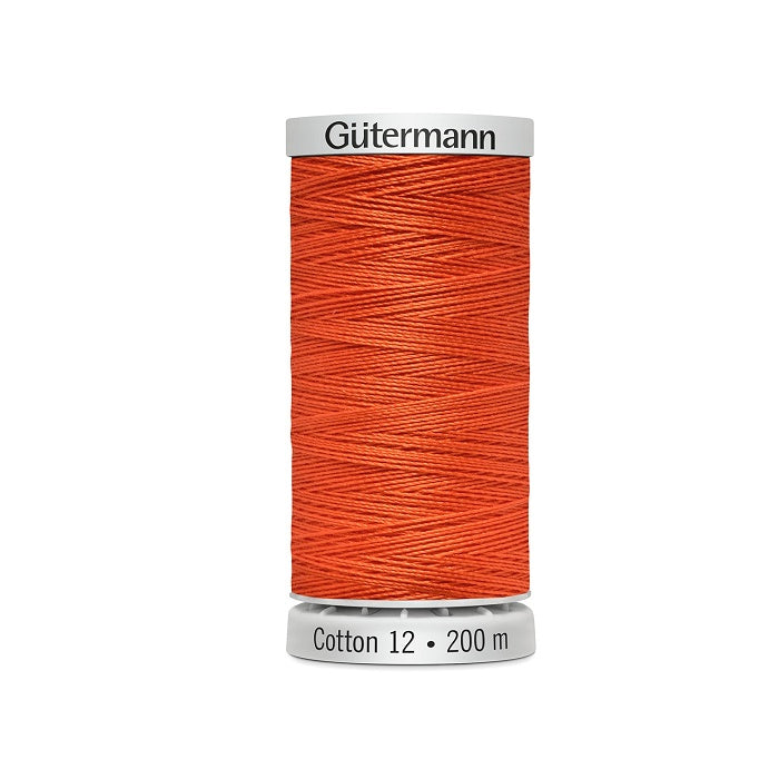 Spool of birght orange thread with Gutermann Cotton 12 branding.