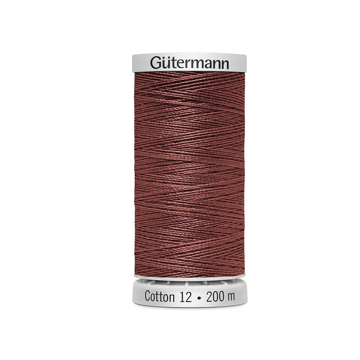 Spool of dark shell pink thread with Gutermann Cotton 12 branding.