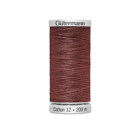Spool of dark shell pink thread with Gutermann Cotton 12 branding.