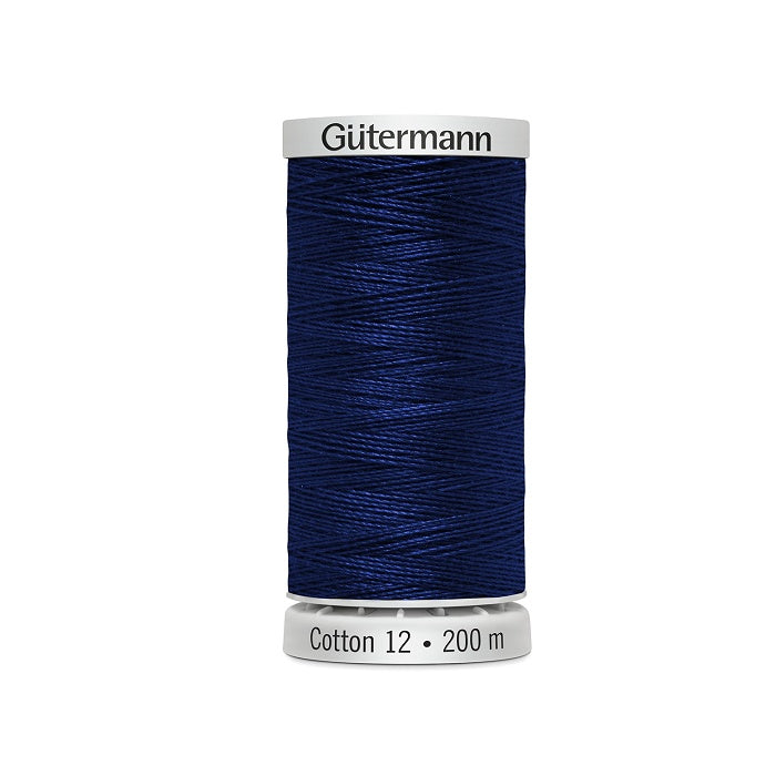 Spool of dark royal blue thread with Gutermann Cotton 12 branding.