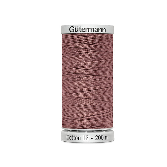 Spool of dark shell pink thread with Gutermann Cotton 12 branding.
