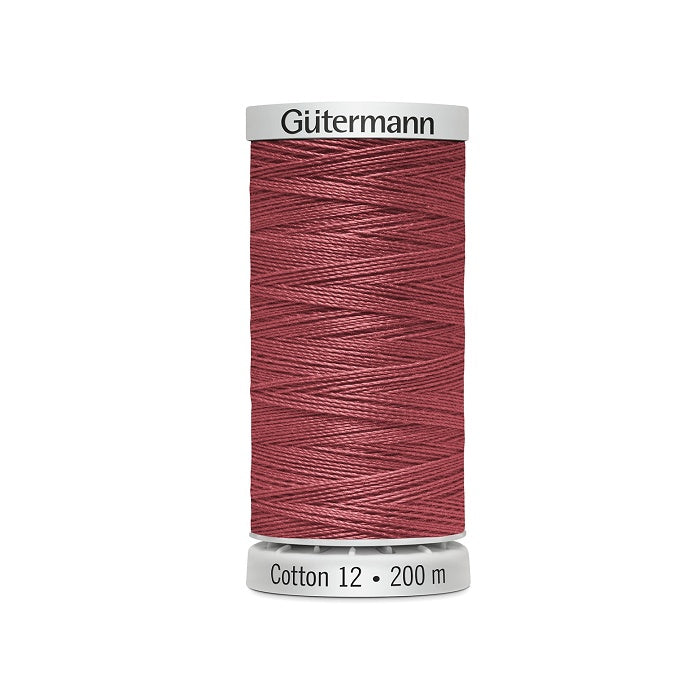Spool of dark dusty pink thread with Gutermann Cotton 12 branding.