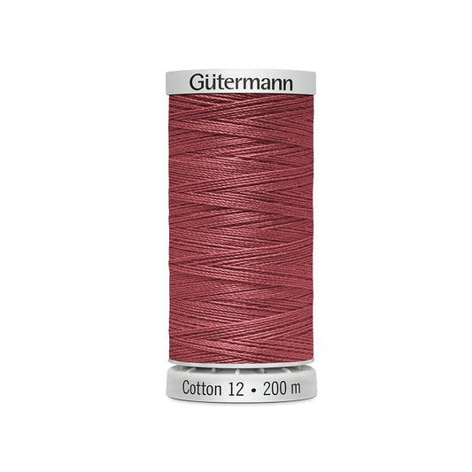 Spool of dark dusty pink thread with Gutermann Cotton 12 branding.