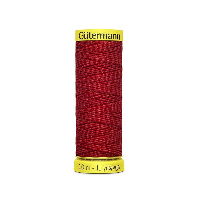 Red elastic sewing thread spool with gutermann branding.