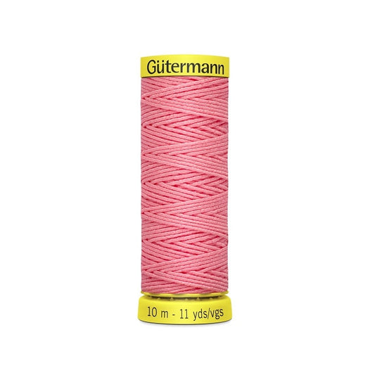 Pink elastic sewing thread spool with gutermann branding.