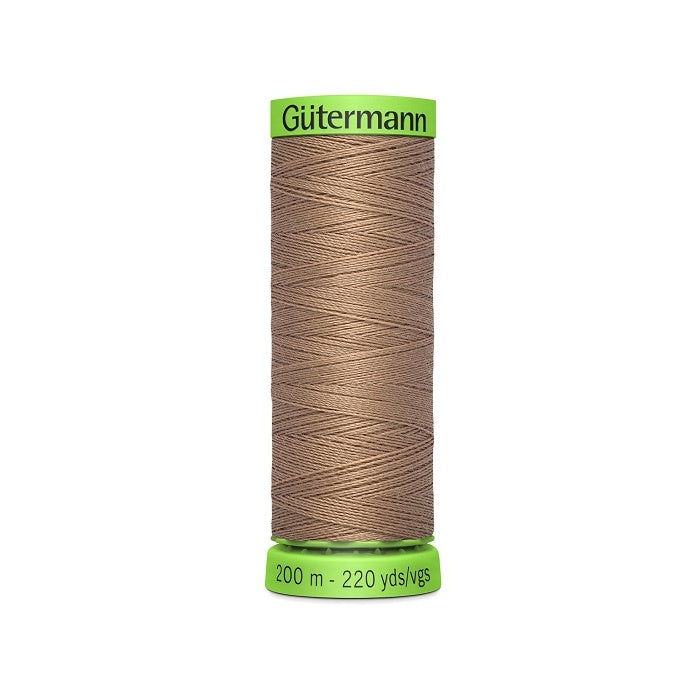 Spool of brown extra fine thread with Gutermann branding.