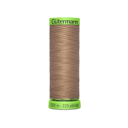 Spool of brown extra fine thread with Gutermann branding.