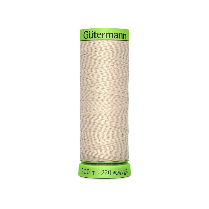 Spool of beige extra fine thread with Gutermann branding.