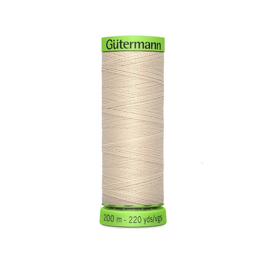 Spool of beige extra fine thread with Gutermann branding.