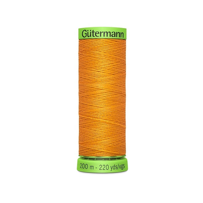 Spool of orange extra fine thread with Gutermann branding.