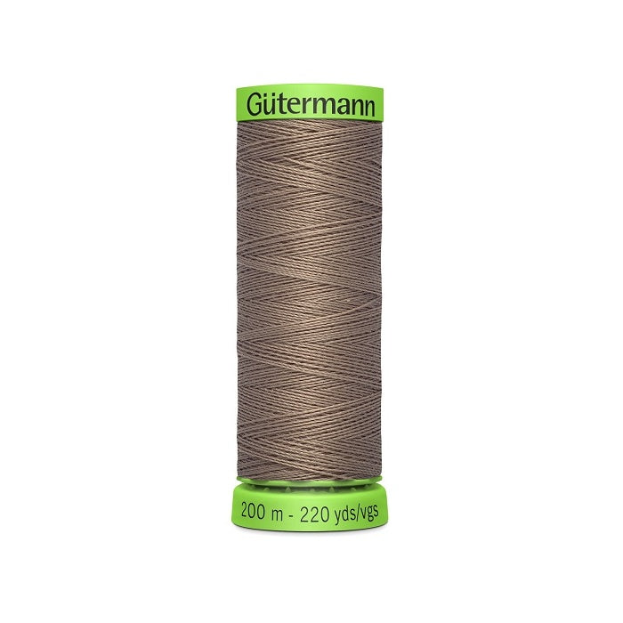 Spool of brown extra fine thread with Gutermann branding.