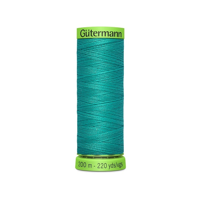 Spool of green extra fine thread with Gutermann branding.