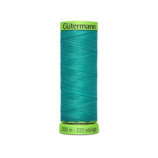 Spool of green extra fine thread with Gutermann branding.