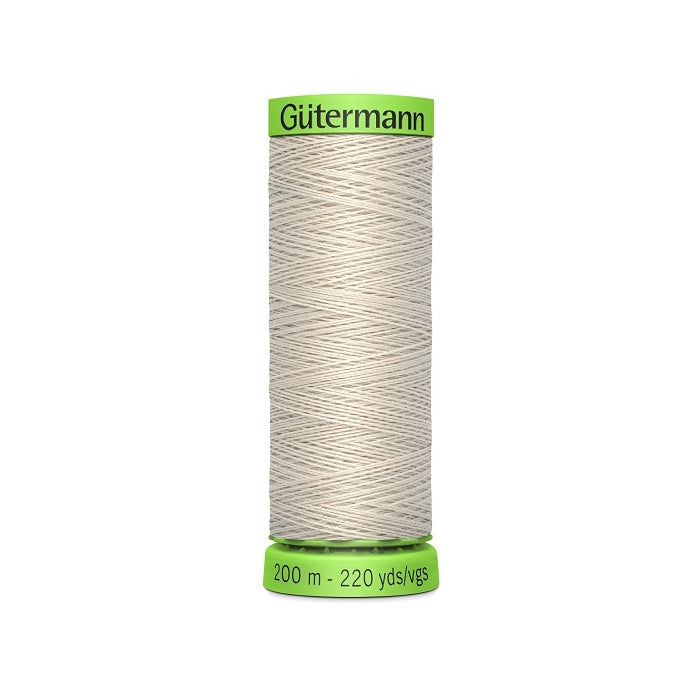 Spool of beige extra fine thread with Gutermann branding.