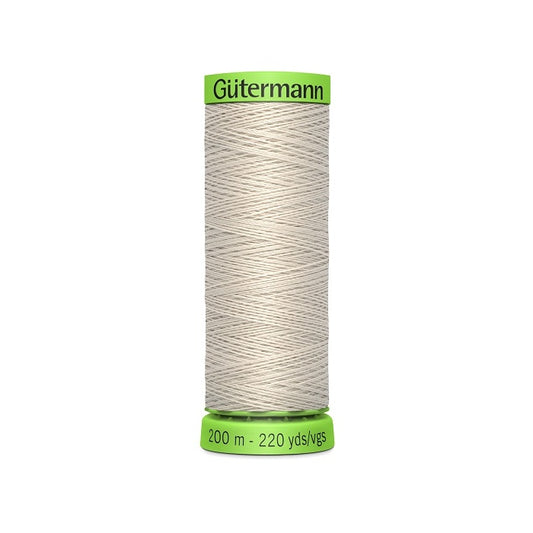 Spool of beige extra fine thread with Gutermann branding.