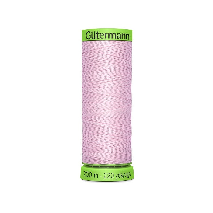 Spool of pink extra fine thread with Gutermann branding.