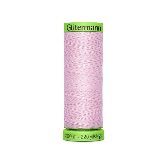 Spool of pink extra fine thread with Gutermann branding.