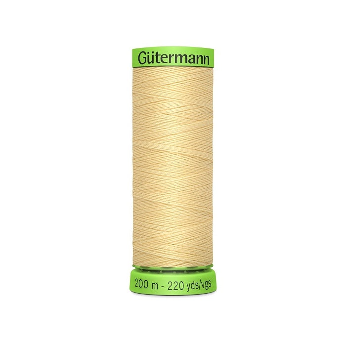 Spool of beige extra fine thread with Gutermann branding.
