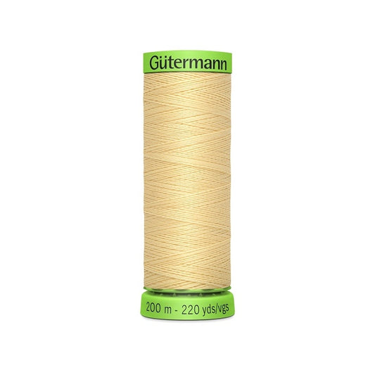 Spool of beige extra fine thread with Gutermann branding.