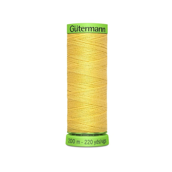 Spool of yellow extra fine thread with Gutermann branding.