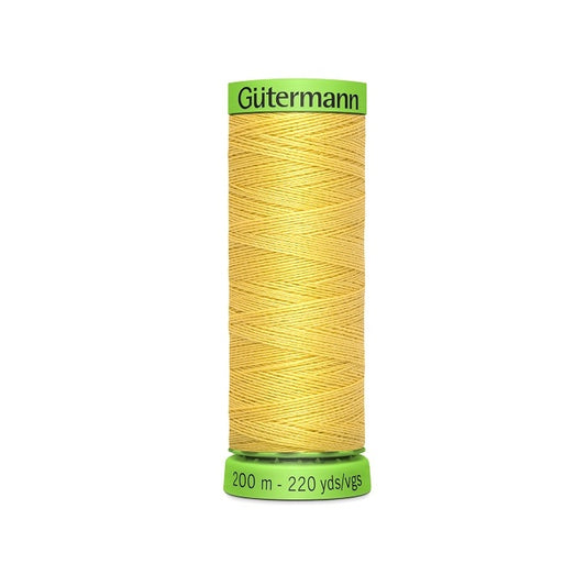 Spool of yellow extra fine thread with Gutermann branding.