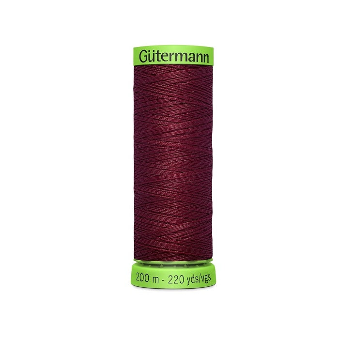 Spool of dark red extra fine thread with Gutermann branding.