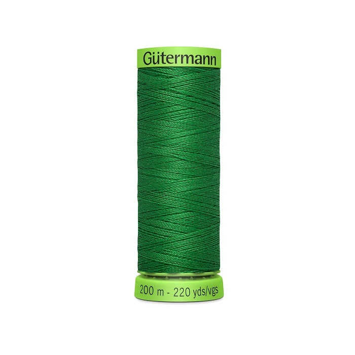 Spool of green extra fine thread with Gutermann branding.