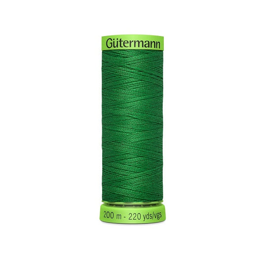 Spool of green extra fine thread with Gutermann branding.