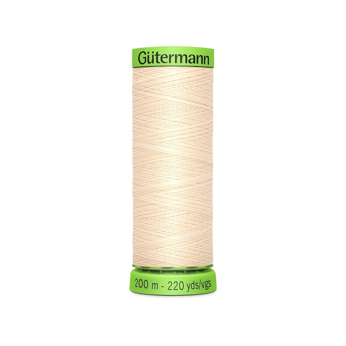 Spool of beige extra fine thread with Gutermann branding.