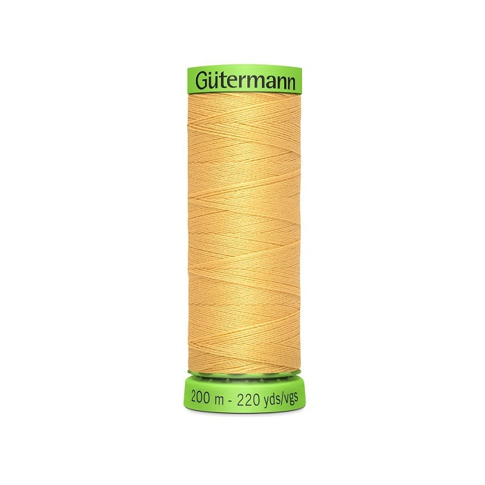 Spool of yellow extra fine thread with Gutermann branding.