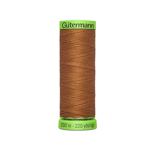 Spool of brown extra fine thread with Gutermann branding.