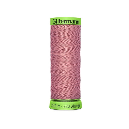 Spool of dark pink extra fine thread with Gutermann branding.