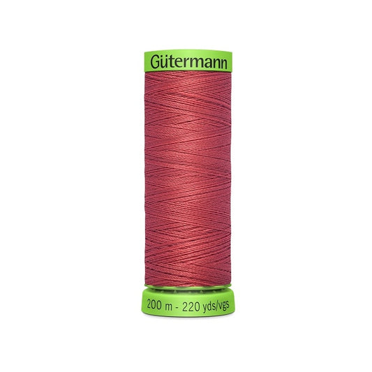 Spool of red extra fine thread with Gutermann branding.
