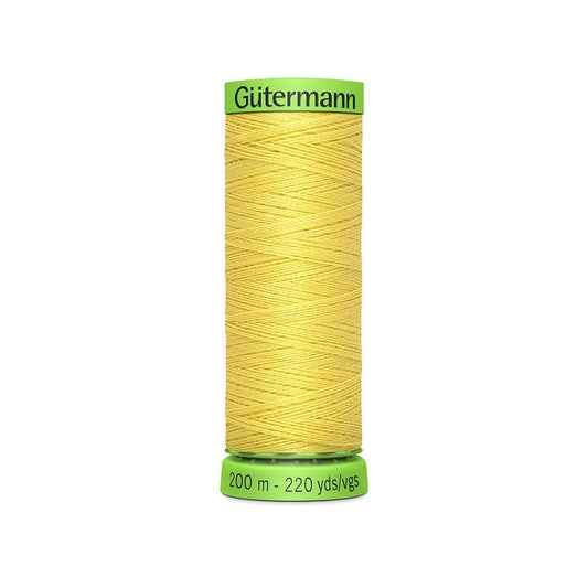 Spool of yellow extra fine thread with Gutermann branding.
