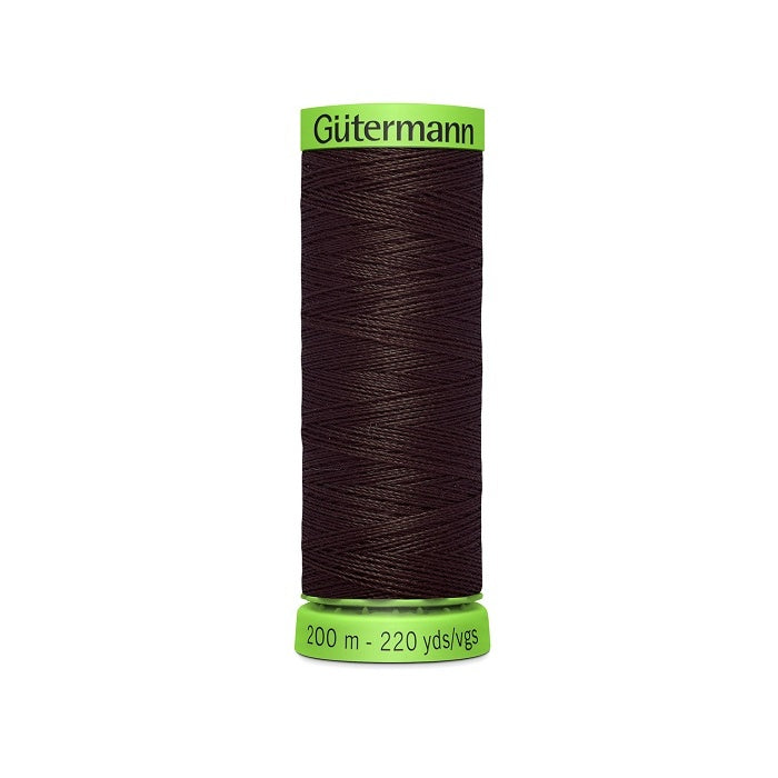 Spool of dark brown extra fine thread with Gutermann branding.