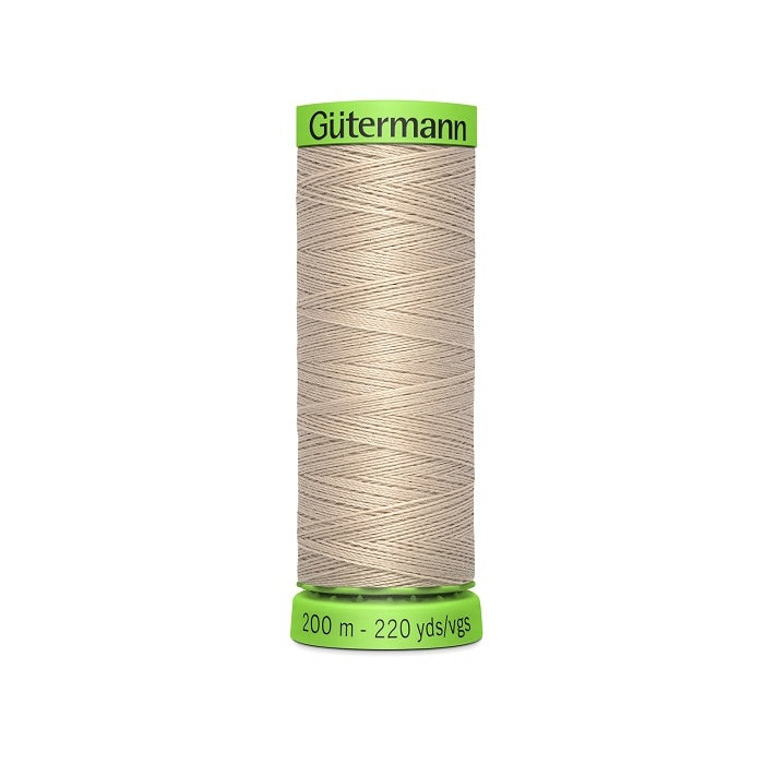 Spool of beige extra fine thread with Gutermann branding.