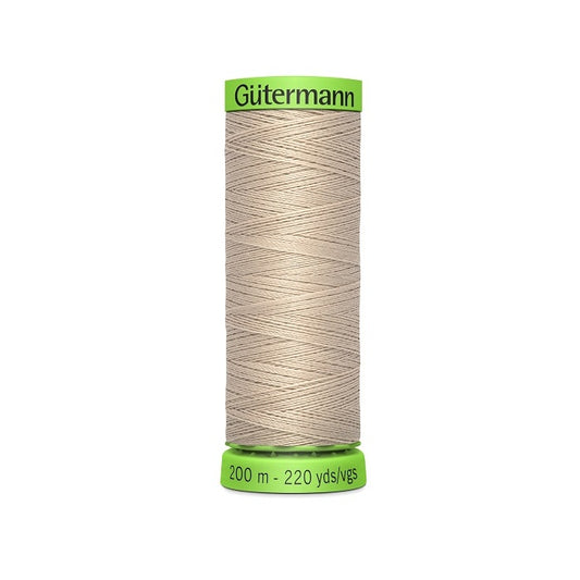 Spool of beige extra fine thread with Gutermann branding.
