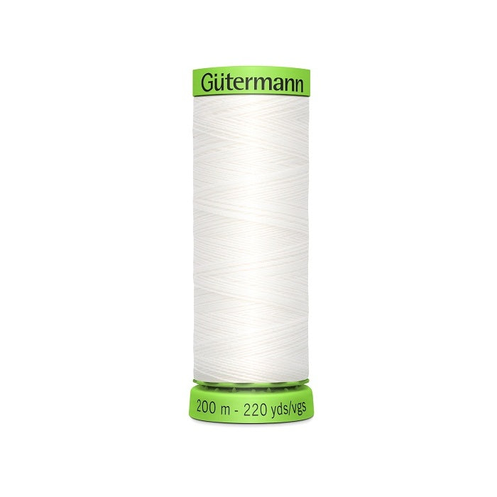 Spool of white extra fine thread with Gutermann branding.