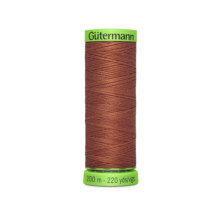 Spool of brown extra fine thread with Gutermann branding.