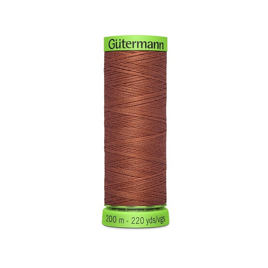 Spool of brown extra fine thread with Gutermann branding.