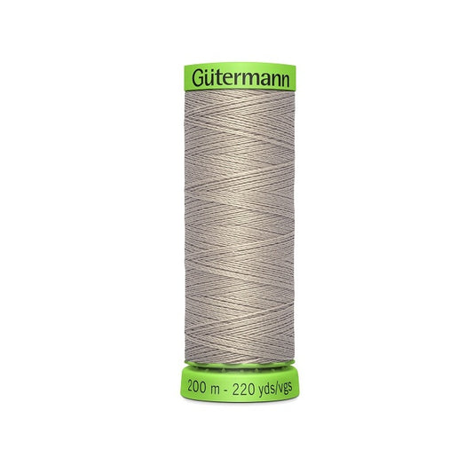 Spool of beige extra fine thread with Gutermann branding.