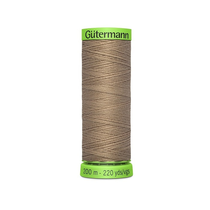 Spool of dark beige extra fine thread with Gutermann branding.