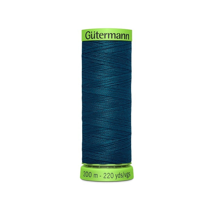 Spool of dark teal blue extra fine thread with Gutermann branding.