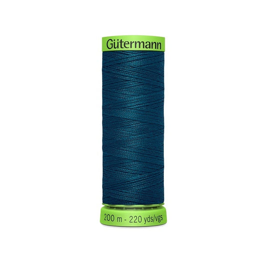 Spool of dark teal blue extra fine thread with Gutermann branding.