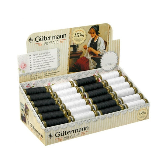 Display box of white and black sewing thread with Gutermann branding.