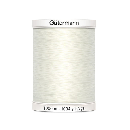 Off white sewing thread spool with Gutermann branding.