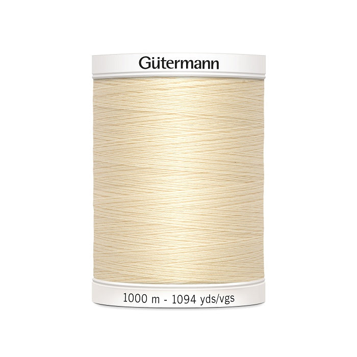 Cream sewing thread spool with Gutermann branding.