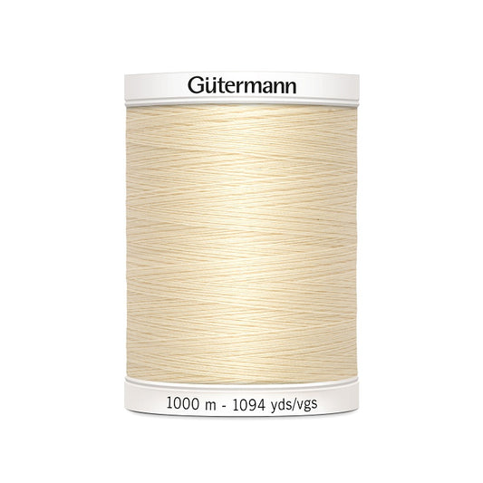 Cream sewing thread spool with Gutermann branding.